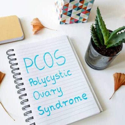 PCOS Polycystic ovary syndrome written in a notebook on white table PCOS, Polycystic Ovary Syndrome, symptoms, causes, treatment, hormonal imbalance, irregular periods, fertility, lifestyle changes